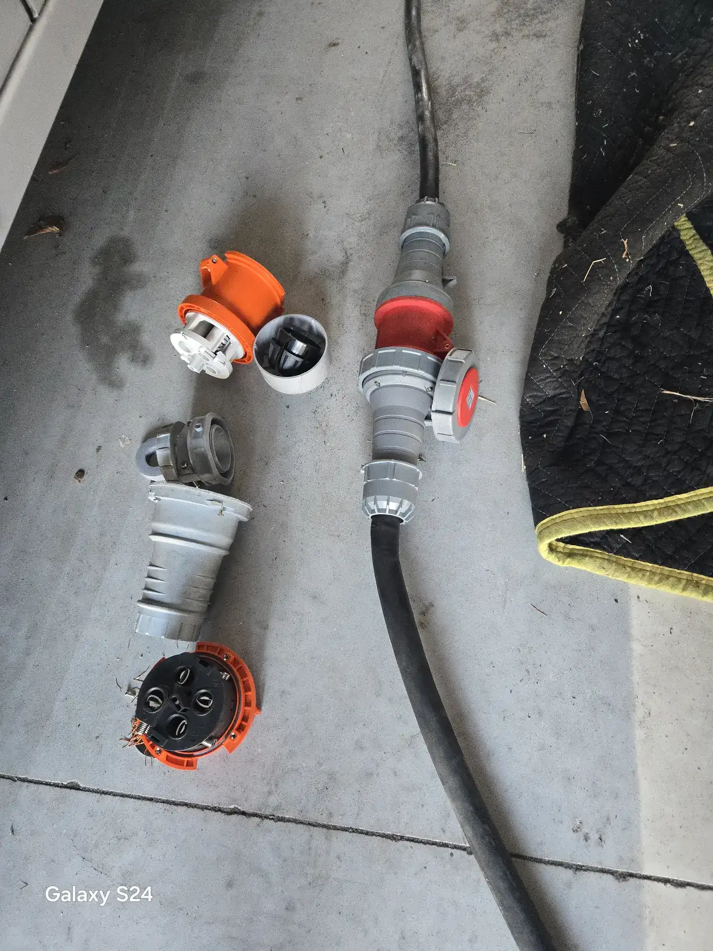 Burnt 50 amp RV shore power cord plug beside a new replacement connector in Sarasota, FL