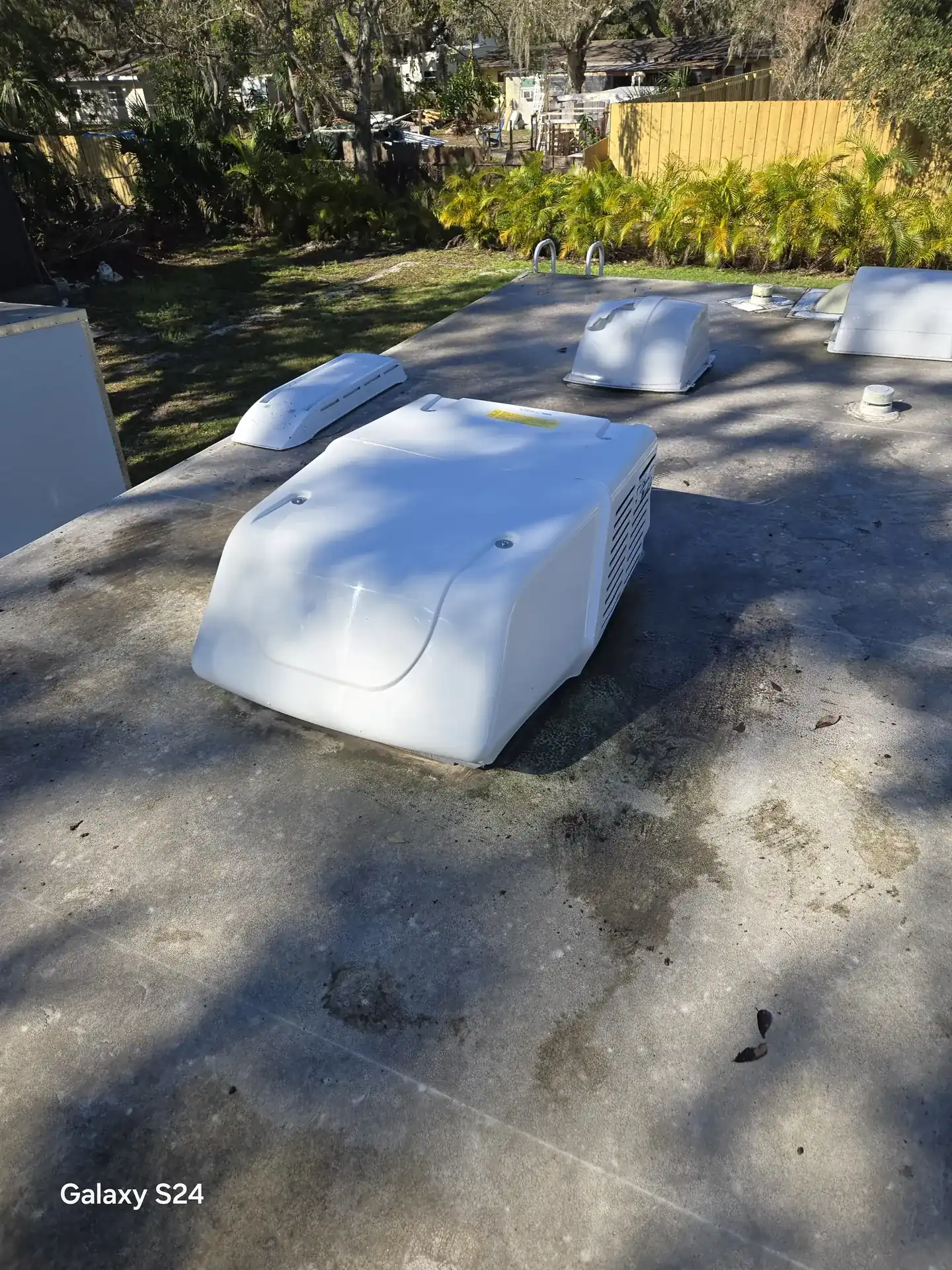 Newly installed white rooftop air conditioner on an RV roof in Sarasota, FL